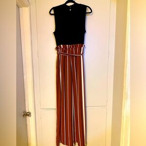 Junior’s sleeveless jumpsuit. Black top with brown/black/white stripes bottom